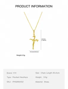 Macro view of brass 18k gold cross necklace pendant with detailed floral vine texture
