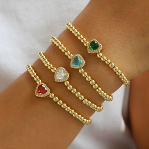 Set of four 18k gold beaded bracelets with colorful heart-shaped cubic zirconia charms