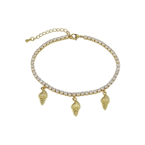 Macro shot of gold-plated starfish and shell charms with pavé cubic zirconia on beach anklet