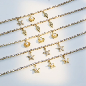 Gold ocean anklets with starfish shell charms and zircon crystals for summer beach vacations