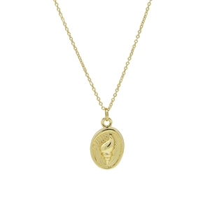 Close-up of golden oval necklace pendant with seashell relief and fine textures