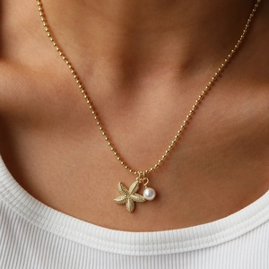 Summer gold beaded necklace with sparkling starfish charm and elegant white pearl pendant