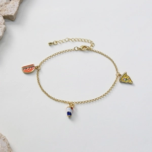 Detail of golden chain anklet with colorful hot dog, soda cup, and pizza enamel charms