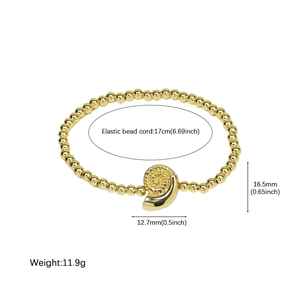 Bracelet extensible à billes dorées avec pendentif coquillage et mesures de bijoux