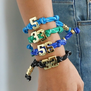 Colorful paracord woven bracelets with gold lucky numbers for team jersey styles