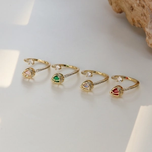 Set of four gold open rings with colorful pear-cut tulip zircon stones and fine inlay