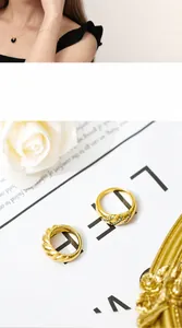Detail of twisted gold ring and pave diamond band set with matching black pendant