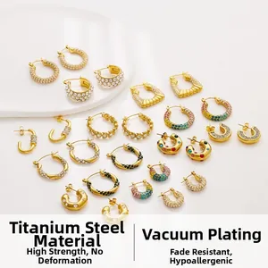 Detailed close-up of 18k gold plated titanium earrings with sparkling zircon inlay