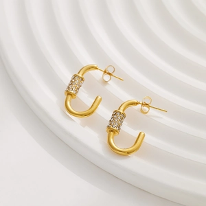 Detail of 18k gold plated C-shaped earrings with micro-inlaid white cubic zirconia stones