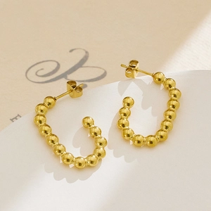 Detail of 18k gold plated stainless steel C-shaped earrings with beaded texture