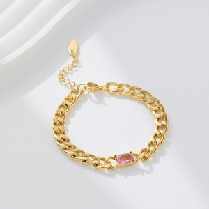 Detail of 18k gold plated cuban chain with rectangular pink zircon gemstone center