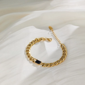 Detail of vintage 18k gold plated stainless steel bracelet with a black zircon stone