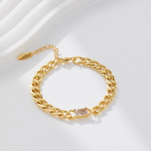 Detailed macro view of 18k gold plated Cuban chain bracelet with rectangular zircon stone