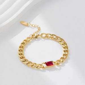 Detail of 18k gold plated Cuban chain bracelet with rectangular red zircon gemstone