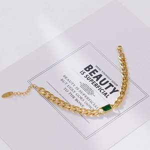 Detail of 18k gold plated Cuban chain bracelet with rectangular green emerald zircon