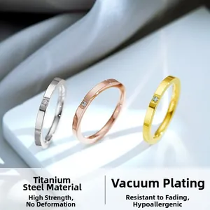 Detalle de anillos de acero de titanio plata, oro y oro rosa con incrustación de circón