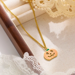 Detail of pumpkin-shaped enamel pendant with gold metal base and soft pink finish