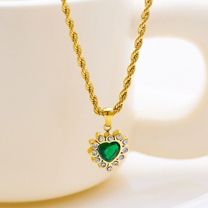 Detailed view of heart-shaped green gemstone necklace with white zircon and gold chain