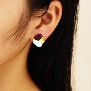 Close-up of vintage malachite drop earrings with three-tone enamel inlay on model