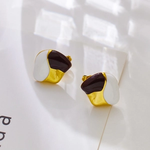 Detail of vintage geometric enamel earrings featuring white and burgundy color blocking