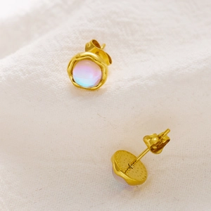 Detail of vintage gold earrings with iridescent malachite stones and hammered texture finish