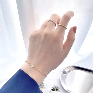 Close-up of 18k gold plated titanium steel bracelet with zircon and stackable rings