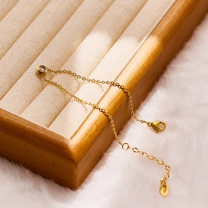 Detailed macro of a 18k gold plated stainless steel chain with round zircon and lobster clasp