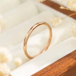 Macro-detail van de gefacetteerde textuur op de minimalistische roségouden titanium stalen ring