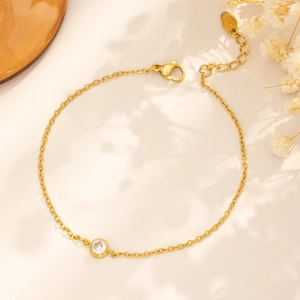 Detail shot of a gold-plated 18k titanium steel bracelet with a single round zircon