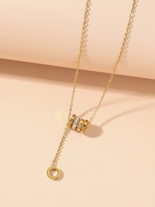 Detailed view of golden stainless steel necklace with interlocking Roman numeral rings