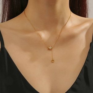 Minimalist gold titanium steel tassel necklace with interlocking rings shown on model