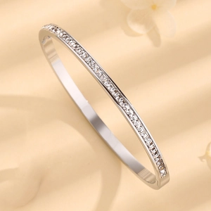 Elegant silver stainless steel bangle with single row of square-cut cubic zirconia