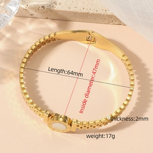 Close-up of gold Roman numeral bracelet with LOVE engraving and shell inlay details