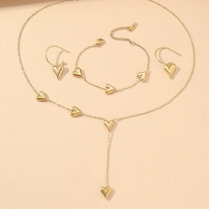 Elegant gold heart jewelry set including a Y-necklace, bracelet, and drop earrings