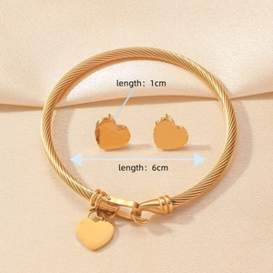 Golden horseshoe heart jewelry set with textured open bangle and stud earrings