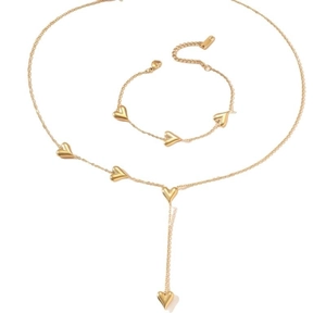 Golden heart tassel necklace and bracelet set featuring minimalist pendant design