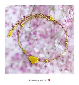 Detailed view of gold heart pendant bracelet with adjustable chain and 18K lobster clasp