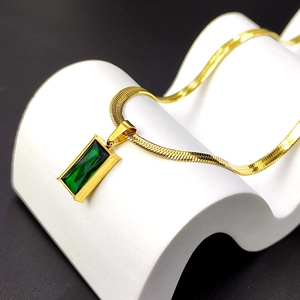 Elegant gold snake chain necklace featuring a rectangular emerald zircon pendant on wave base