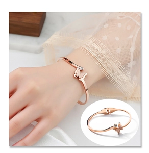 Detailed view of rose gold butterfly cuff bracelet with frosted texture and zircon accent