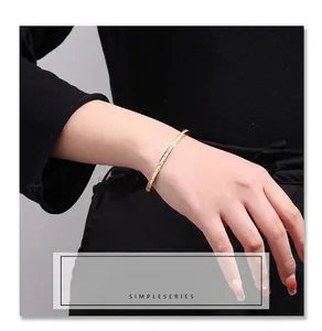 Detailed macro view of a slim gold titanium steel bangle with shimmering pave stones