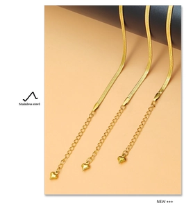 Detail of 18K gold stainless steel snake chain with heart charm and extension links