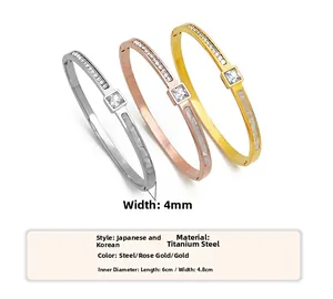 Detail view of gold, rose gold and silver titanium steel bracelets with cubic zirconia stones