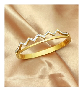 Detail of gold-plated stainless steel hinged bangle with wave zircon pavé setting