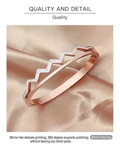 Close-up of rose gold stainless steel open bangle with sparkling rhinestones on satin