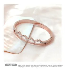 Detail of rose gold 316L stainless steel bracelet with crystal pavé heartbeat pattern