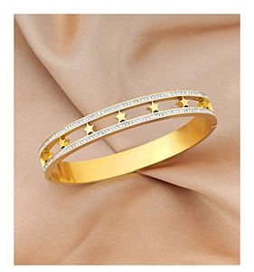 Detailed close-up of golden hollow star bangle with shimmering zircon stones