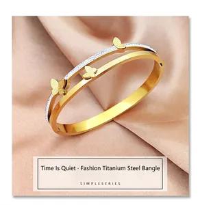 Detailed macro view of gold titanium steel bangle with frosted butterflies and fine crystals