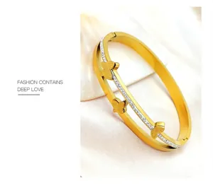 Detailed macro shot of a double-layered gold butterfly bangle with sparkling rhinestones
