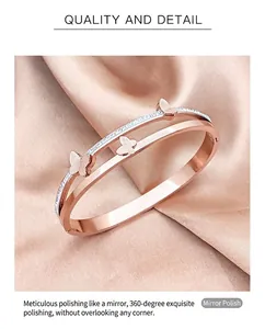 Close-up of rose gold butterfly bangle with double-row diamonds and mirror polished finish
