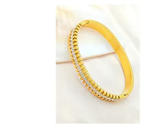 Detail of golden gear-shaped bracelet with inlaid diamonds on beige silk background